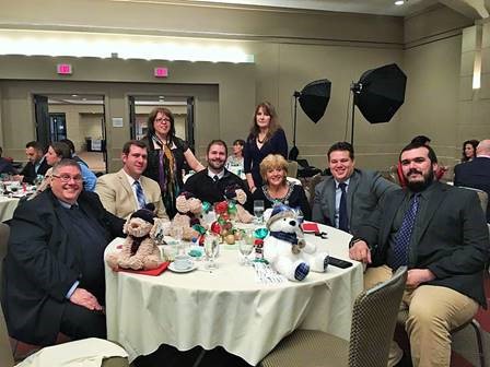 A picture of Paul Avery at the Detroit Intermodal Society's annual charity christmas dinner. Paul is on the far left. To his right is Marcus Carbajo, Linda Thompson, Brett Ouellette, Andrea Blasengym, Susan Dysarczyk, Andrew Bouchard and Steven Joppich